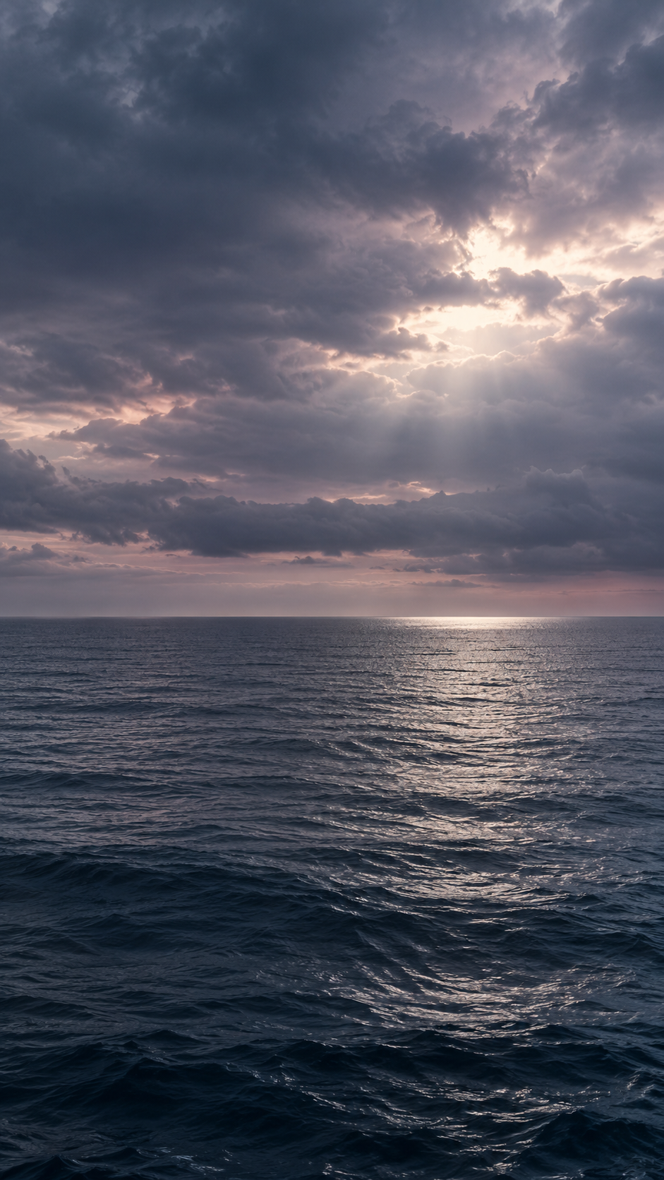 Dramatic clouds with light breaking through above the sea